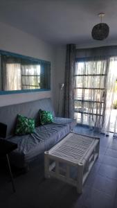a living room with a couch and two windows at fuerte blue in Costa Calma