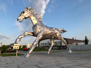 a statue of a horse in front of a building at Šamorín - apartment in the center - free parking in Šamorín