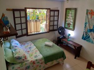 a bedroom with a bed and a window at Casa inteira Ilha Grande in Abraão