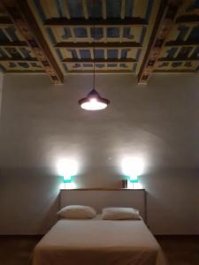 a bedroom with two beds and a ceiling with lights at pietrolafontaine19 in Viterbo