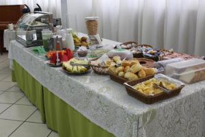 a table with baskets of fruits and vegetables on it at Hotel Ipanema Inn Higienópolis in São Paulo +39 photos