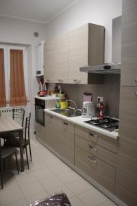 cocina con fregadero y fogones horno superior en Affittacamere LA PISANA, en Porto SantʼElpidio