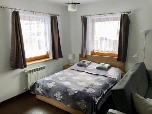 Łóżko lub łóżka w pokoju w obiekcie Apartamenty u Krysi