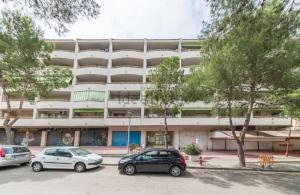 a parking lot in front of a large building at Marathon in Salou