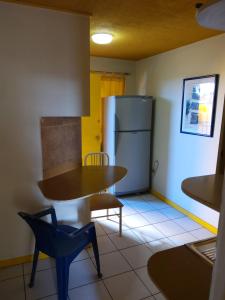 a kitchen with a table and a refrigerator at Resimed in Antofagasta