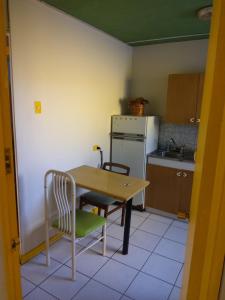 una cucina con tavolo, 2 sedie, tavolo e frigorifero di Resimed ad Antofagasta