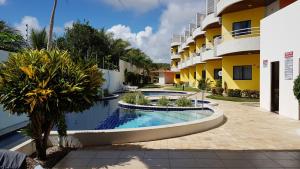 a swimming pool in a courtyard of a building at Ocean View Tabatinga Residence in Barra de Tabatinga