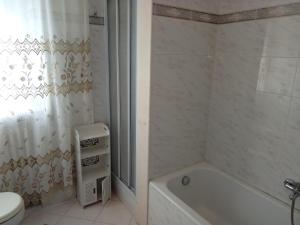 a bathroom with a tub and a toilet and a shower at acqua di mare in Taranto