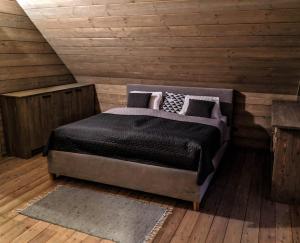 a bedroom with a bed in a wooden room at Chata Čerenka in Bytca