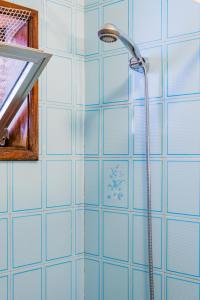 a shower stall with a blue shower curtain at Casa dos Azulejos in Matosinhos