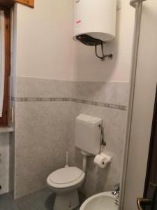 a small bathroom with a toilet and a sink at da Alessandra e Fabio in Miroglio