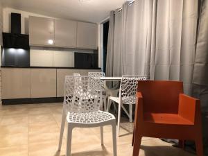 a kitchen with a table and chairs in a room at Be On The Beach in Sainte-Anne