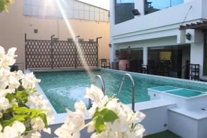a swimming pool with a fountain in a house at Muong Thanh Vung Tau Hotel in Vung Tau