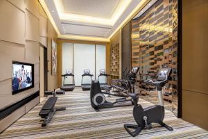 a gym with a row of treadms and cardio machines at Somerset Grandview Shenzhen in Shenzhen
