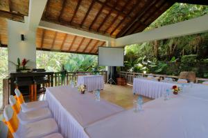 a room with tables and chairs and a projection screen at The Bejalin Eco Retreat in Plaga