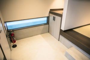 an empty room with a door and a window at MUSUBI HOTEL MACHIYA Naraya-machi 1 in Fukuoka +38 photos