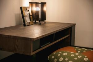 a wooden desk in a room with a bed at MUSUBI HOTEL MACHIYA Naraya-machi 1 in Fukuoka