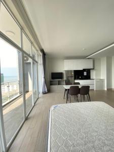 a kitchen and dining room with a view of the ocean at The Hill Residence in Sihanoukville