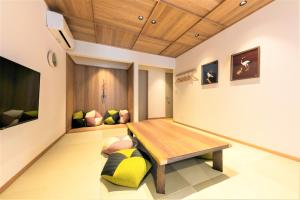 a room with a wooden table and a bench at MUSUBI HOTEL MACHIYA Naraya-machi 2 in Fukuoka