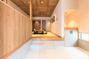 a hallway of a house with a bench and a table at MUSUBI HOTEL MACHIYA Naraya-machi 2 in Fukuoka