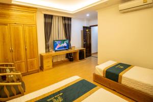 a bedroom with a bed and a television in it at Palette Melissa Ninh Binh - Near Hoa Lu Ancient Town in Ninh Binh