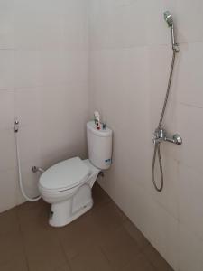 a bathroom with a toilet and a shower at Villa B9us Batu in Karangploso +5 photos