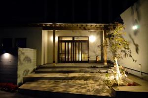 湯布院的住宿－Yufuin Tsuru no Yu，夜间有门的建筑物入口