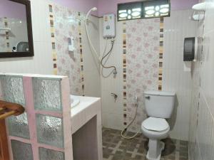 a bathroom with a toilet and a sink and a shower at Mama O Chai Koh Tao in Koh Tao