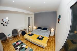 - une chambre avec un lit et une couverture jaune dans l'établissement Apartment Jana, à Sombor