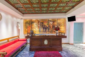 a large room with a desk and a red couch at Earl's Red Colombo in Colombo