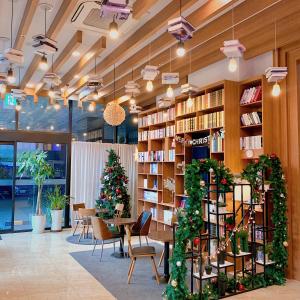 a library with christmas trees and a table and chairs at CS Premier Hotel in Anyang