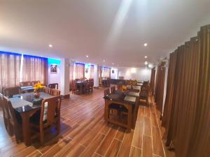 a dining room with wooden tables and chairs at HOTEL ARMS near SUMI Boys School in Kalimpong