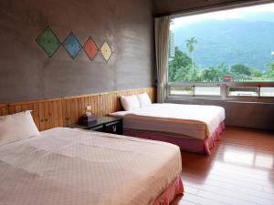 Postel nebo postele na pokoji v ubytování Ying Tian Ye Homestay