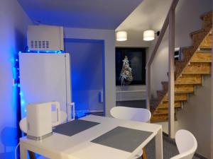 a kitchen with a white table and a refrigerator at Apartamenty Martushka in Karpacz