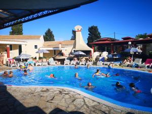 a group of people swimming in a swimming pool at Mediterranean Blue in Kavos