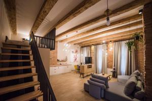 a living room with a couch and a staircase at Casa Verde - Brasov Homes in Braşov