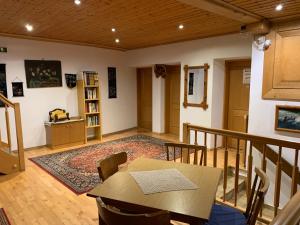 a living room with a table and a rug at Klammer Gasthof in Kremsbrücke