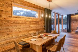 a wooden dining room with a table and chairs at Biochalet-Ebenbauer in Schladming