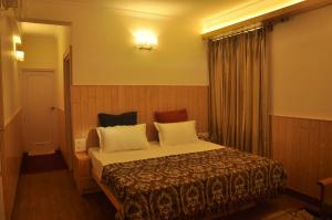 Postel nebo postele na pokoji v ubytování Vatsalyam Home Stay