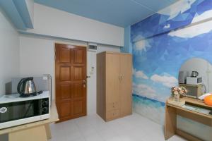 a kitchen with a mural of a coffee maker on the wall at MS Mansion in Bangkok