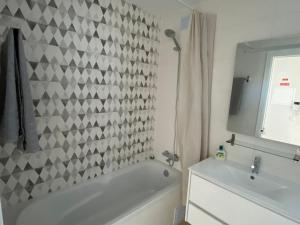 a bathroom with a white bath tub and a sink at Albur Village B - Gerbera in Alvor +12 photos