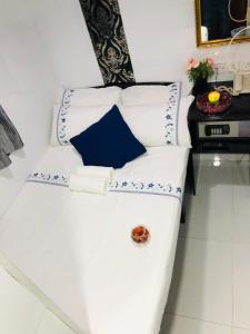 a white couch with blue and white pillows at Ashoka Hostel in Hong Kong