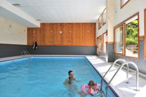 two children swimming in a swimming pool at Les Hauts Valmeinier in Valmeinier