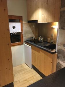 a kitchen with a sink and a counter top at La cavalièra in Polminhac