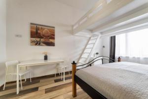 a white bedroom with a bed and a desk at Bilkova Old Town Residence in Prague