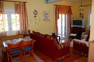 a living room with a couch and a table at Vanna's Holiday House in Ierissos