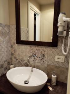 a white sink in a bathroom with a mirror at Casa D'amore in Riomaggiore