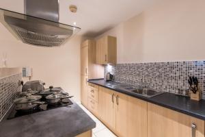 a kitchen with pots and pans on a stove at South Road View in Durham