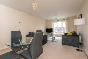 a living room with a glass table and chairs at South Road View in Durham