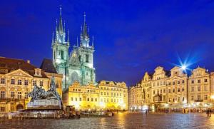 a view of a city at night with a church at Bilkova Old Town Residence in Prague